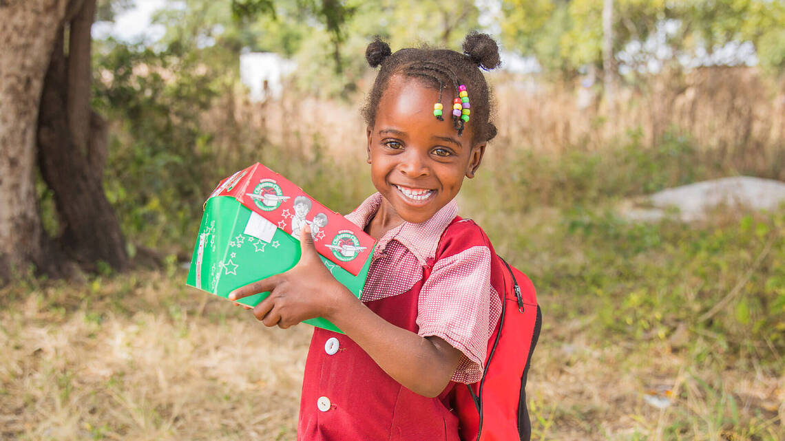 Child holding Christmas gift box